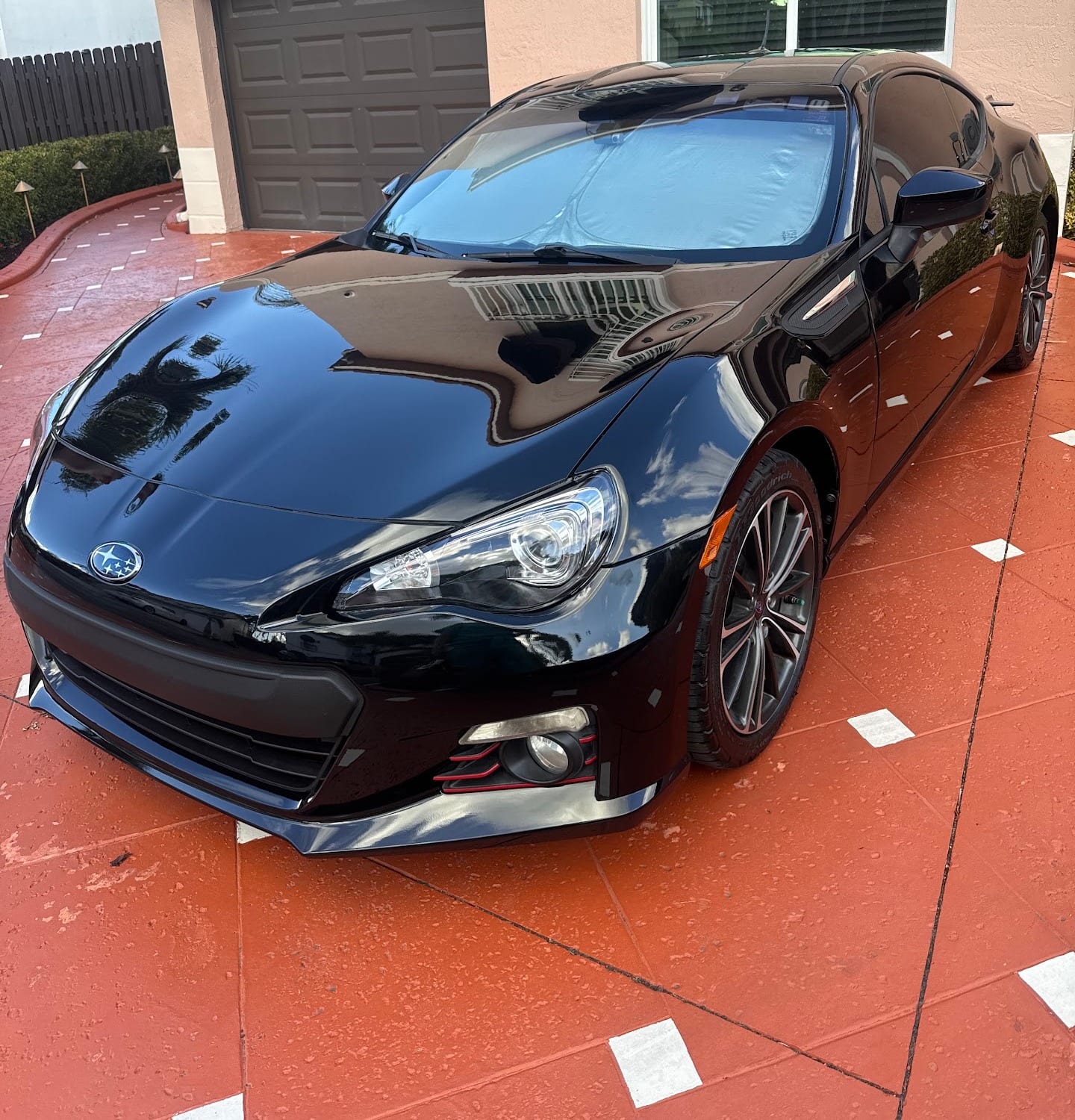The same black Subaru BRZ after repair, front end straight and paint glossy